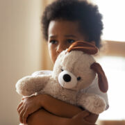 Little Boy Holding Stuffed Animal