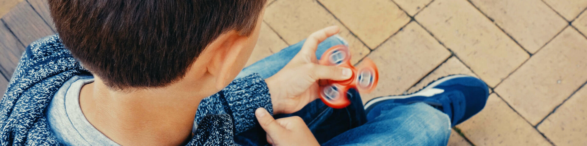 Boy using fidget spinner